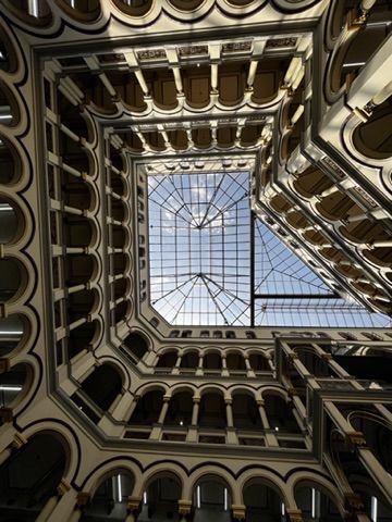 Looking up at an old glass atrium.