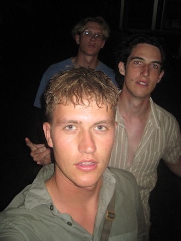Three friends close to camera at night, candid.
